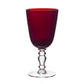 A Fanny Scarlet Drinkware Collection deep red wine glass with a clear, decorative stem and base, crafted in vibrant scarlet barware.