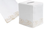 Discover the Scrollfish Bath Collection in cream by Haute Home, featuring a white linen tissue box cover with a delicate gold swirl hand embroidery. A coordinating fabric piece on the left enhances its elegant appeal.
