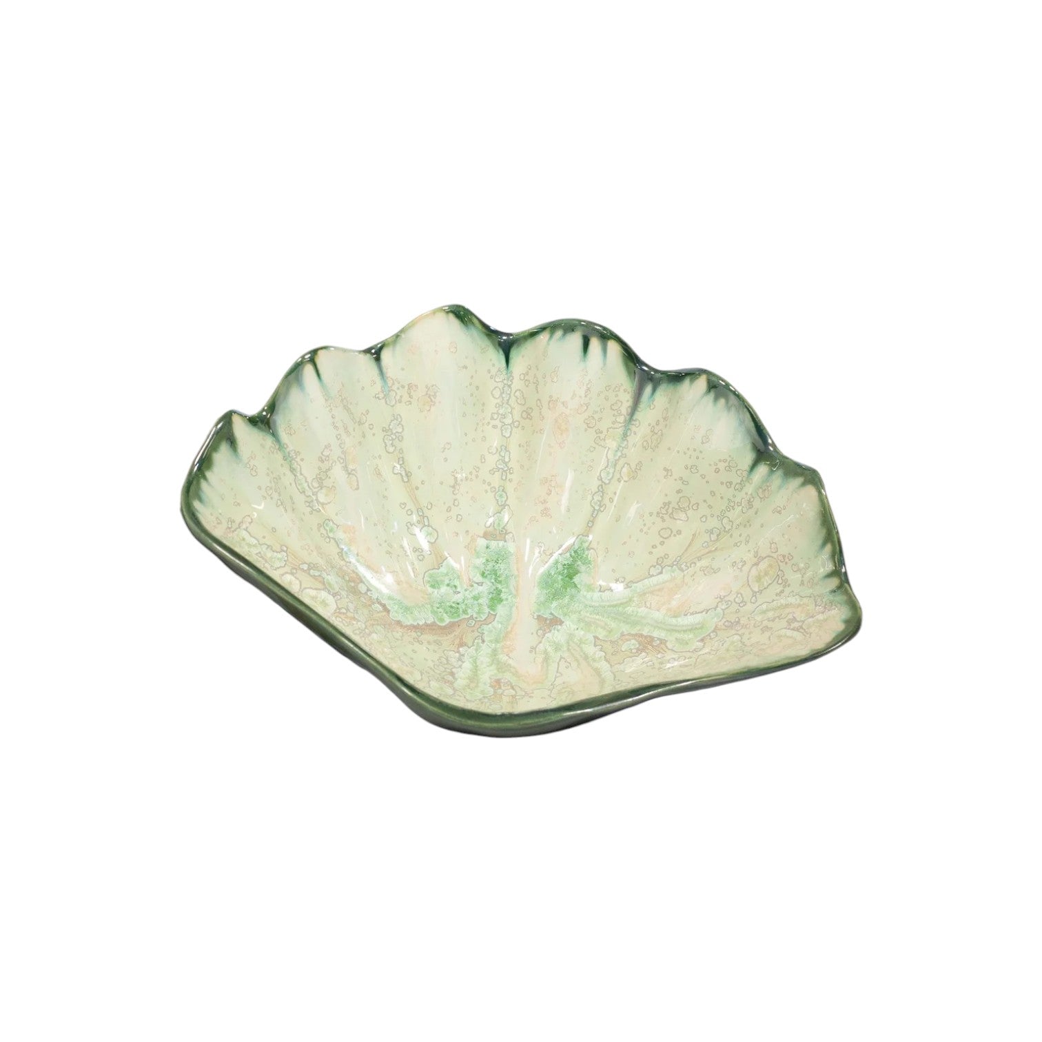 The AE Ceramics Mint & Charcoal Serveware Collection features a ceramic scallop shell dish in green and cream, combining style and function, shown on a white background.