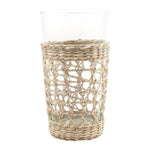 The Be Home Seagrass Cage Glassware Collection features clear glass tumblers partially wrapped in removable seagrass, blending natural style with modern design.