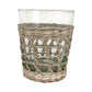 The Be Home Seagrass Cage Glassware Collection features clear glass tumblers partially wrapped with woven rattan, ideal for those who love unique seagrass-inspired drinkware.