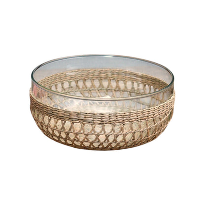 The Removable Seagrass Cage by Be Home features a clear glass bowl encased in a handwoven rattan outer layer, with intricately woven seagrass details that add charming texture—perfect for enhancing rustic decor, shown on a white background.