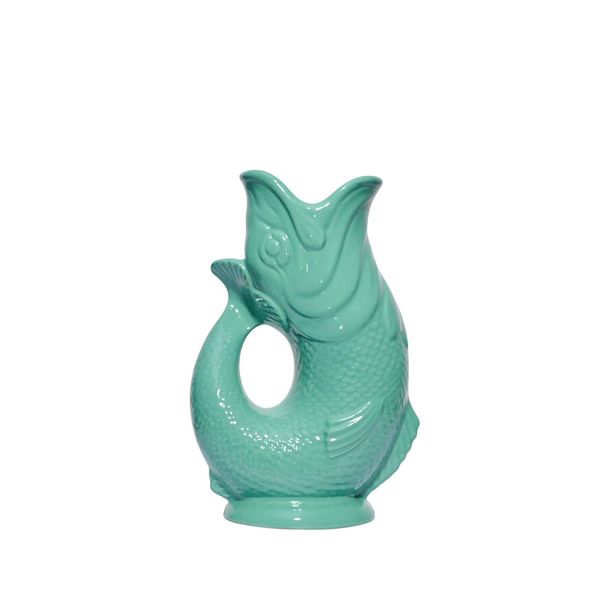 The Original Gluggle Jug's Fish Gluggle Jug Collection features ceramic jugs shaped like fish with glossy turquoise glaze, open mouth spout, and loop handle—an iconic British design.