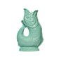The Original Gluggle Jug’s Fish Gluggle Jug Collection features glossy, turquoise ceramic pitchers shaped like fish with textured scales and a tail handle—an iconic example of British design.