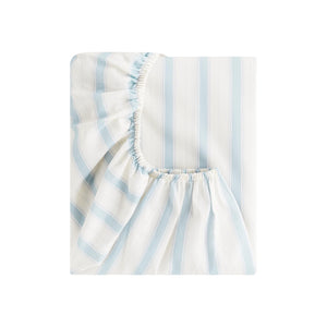 The Gooselings Seaside Stripes Bedding is a blue and white striped fitted sheet with elastic edges, crafted from pure materials and OEKO-TEX certified, shown folded against a plain white background.