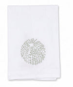 Introducing the Sea Urchin Bath Collection by Haute Home: a refined Italian linen cloth napkin featuring a circular, dotted light green pattern at its center, neatly folded against a plain white background—an elegant piece from Haute Home’s premium collection, perfect for enhancing your home décor.