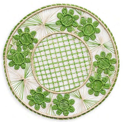 Handcrafted in Colombia, the Serenity Rattan Placemat Collection by Themis Z features round woven placemats with green flower shapes and a lattice center, showcasing a vibrant green and cream pattern.