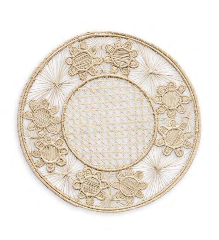 Themis Z’s Serenity Rattan Placemat Collection features round, handcrafted placemats with a woven lattice center and decorative floral edge, made from natural fibers.