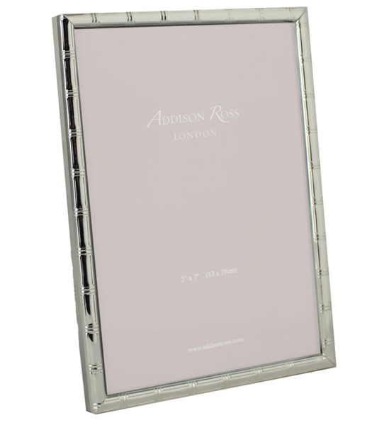 The Addison Ross Cane Silver Frame Collection features an elegant silver-plated vertical picture frame with "Addison Ross London" on the placeholder. It fits a 5" x 7" photo, adding sophistication to any space.