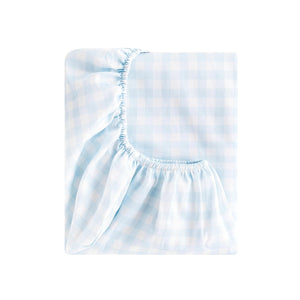 The Gooselings Blue Picnic Gingham Bedding Collection features a folded light blue and white gingham fitted bed sheet with elastic edges, made from pure materials. OEKO-TEX certified for safety and comfort. Displayed on a white background.