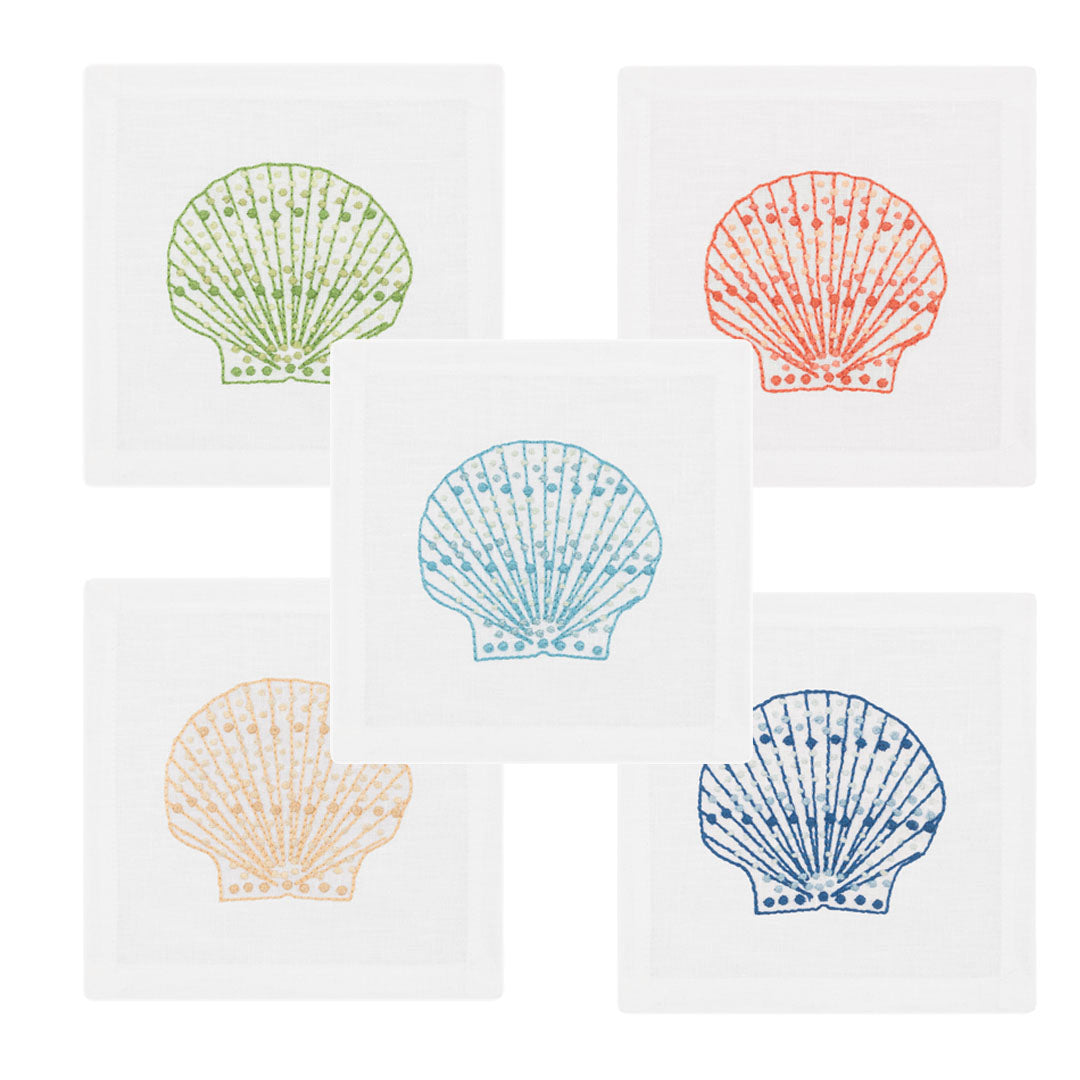 The Haute Home Speckled Shell Coaster Set includes five white Italian linen coasters, each hand embroidered with a scallop shell in green, orange, light blue, yellow, or dark blue.
