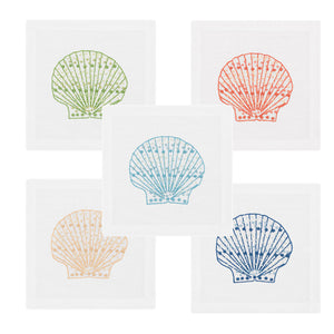 The Haute Home Speckled Shell Coaster Set includes five white Italian linen coasters, each hand embroidered with a scallop shell in green, orange, light blue, yellow, or dark blue.