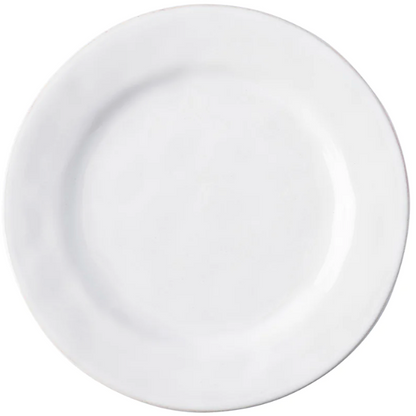 The Juliska Puro Whitewash Dinnerware Collection features a round, white ceramic plate photographed from above on a white background, offering a neutral palette ideal for serving teatime treats or savory tapas.