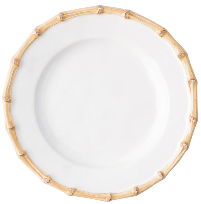 The Juliska Classic Bamboo Dinnerware Collection features a white ceramic plate with a light brown bamboo-like rim, adding casual elegance and making it a standout piece for your table.