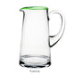 The Siena Pitcher Collection by William Yeoward Crystal features clear glass with a green-tinted rim and handle, offering a stylish pop of color. "Green" appears below the pitcher. Proposition 65 warning applies.