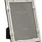 The Wide Bamboo Silver Plated Frame Collection by Addison Ross features a 5x7 inch frame in a bamboo design, finished in silver plate and standing upright with a black flexible easel support.