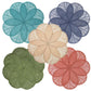 Five overlapping placemats from the Deborah Rhodes Sinamay Flower Placemat Collection Set, in blue, navy, green, peach, and coral woven abaca fibers, are arranged in a circular pattern on a white background.