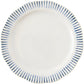 The Juliska Sitio Stripe Delft Blue Dinnerware Collection features a round white ceramic plate with a scalloped edge and radiant blue stripes along the rim—perfect for elevating any tabletop setting.