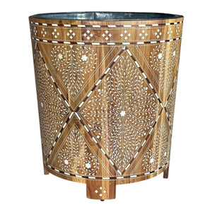 The Bojay Large Wood and Bone Planter showcases intricate white floral bone inlay on wood, with a round tapered shape and four short legs for an elegant touch.