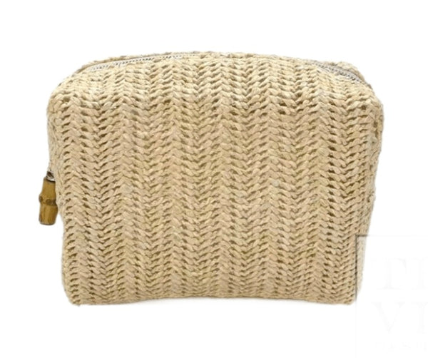 A beige knitted TRVL Bag from the Straw Sand Collection, with a bamboo zipper puller, displayed on a white background.