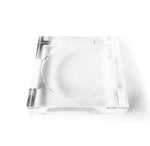 A square, minimalist Lucite Soap & Candle Tray by L’Avant Collective featuring a circular indentation in the center.