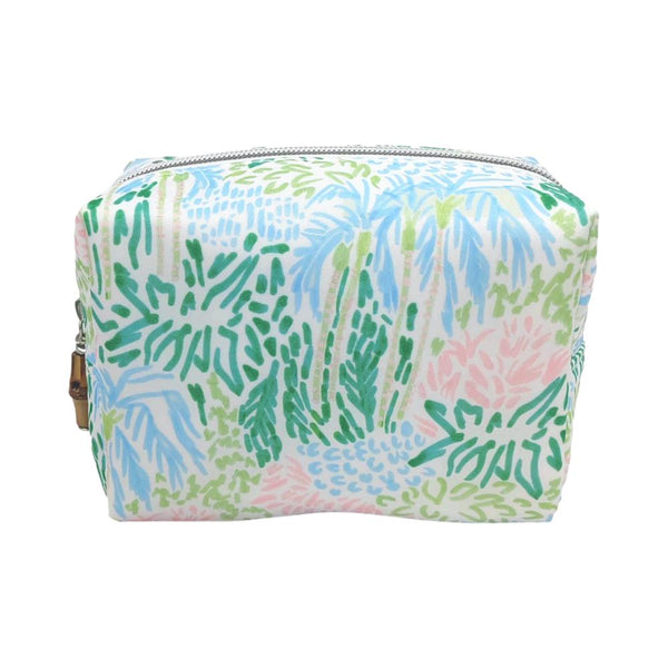 A small, dome top zip TRVL cosmetic bag featuring a colorful tropical leaf pattern in shades of green, blue, and pink on a white background from the Palm Isle Collection by TRVL Design.