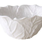 A white ceramic bowl with a wavy, leaf-textured design from the Vida Lettuce Serveware Collection by Beatriz Ball.