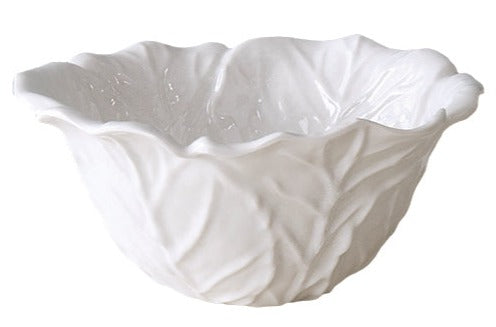 A white ceramic bowl with a wavy, leaf-textured design from the Vida Lettuce Serveware Collection by Beatriz Ball.