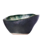 The AE Ceramics Small Sauce Bowl Collection features handmade, asymmetrical bowls with a dark blue exterior and green glazed interior—ideal for adding an artisanal touch to your ceramic dinnerware set.
