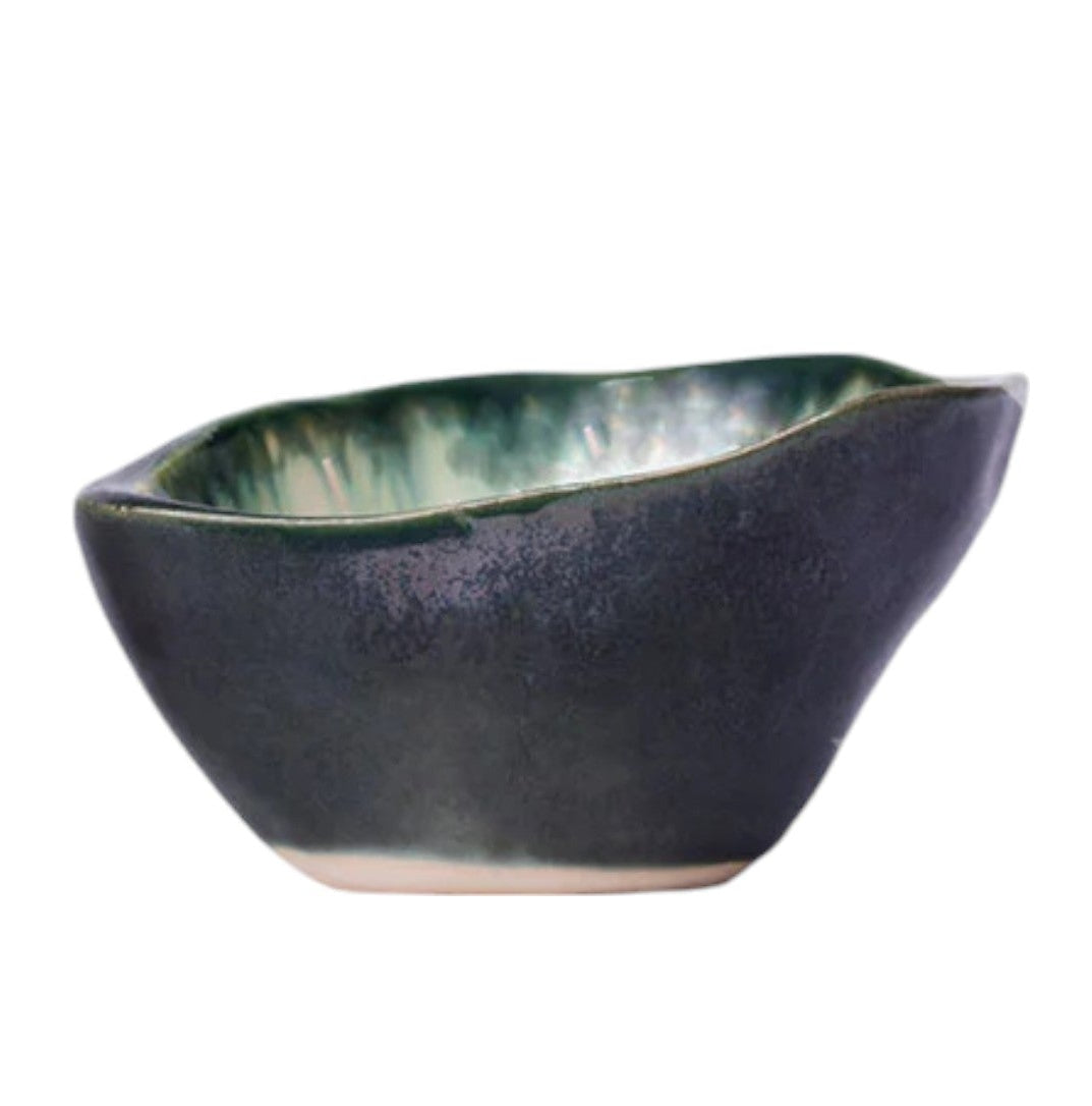The AE Ceramics Small Sauce Bowl Collection features handmade, asymmetrical bowls with a dark blue exterior and green glazed interior—ideal for adding an artisanal touch to your ceramic dinnerware set.