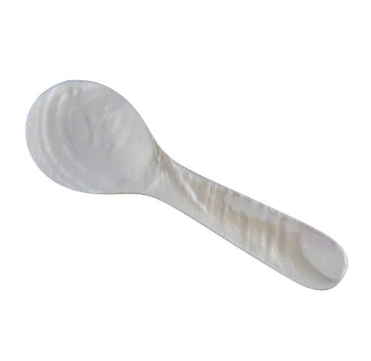 The Be Home Small Seashell Spoon features a rounded bowl and short, flat handle. Ethically sourced and handcrafted by women artisans, it is shown against a white background.