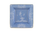 Square blue ceramic plate from the Oriente Italiano Pervinca Serveware & Decor Collection by Ginori 1735, featuring white floral patterns, a gold rim, and raised inner border, photographed on a white background.