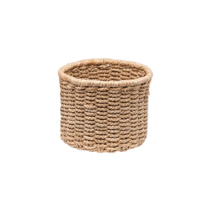 The Yuma Round Basket by Pigeon & Poodle features stylish, natural brown braided fibers for chic storage, displayed against a plain white background.