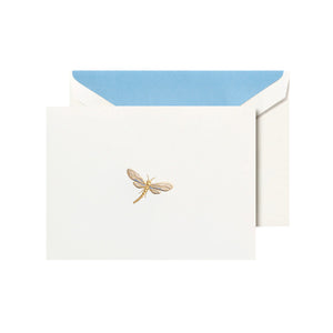 The Crane Dragonfly Card Set features a white card with a gold dragonfly illustration, partially tucked into an envelope lined with blue.
