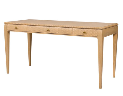 The Sofia Desk by Bunny Williams features a light grey-washed oak finish, three front drawers, rounded edges, and tapered legs.