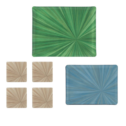 A bold table setting features HestiaLiving's Soleil Tribeca Decor Collection: one large green placemat, one medium blue placemat, and four small tan sunburst coasters, all shown on a white background.