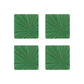 Four green square coasters from the HestiaLiving Soleil Tribeca Collection, featuring a radiant sunburst design, are arranged in a 2x2 grid on a white background—perfect for enhancing any table setting.