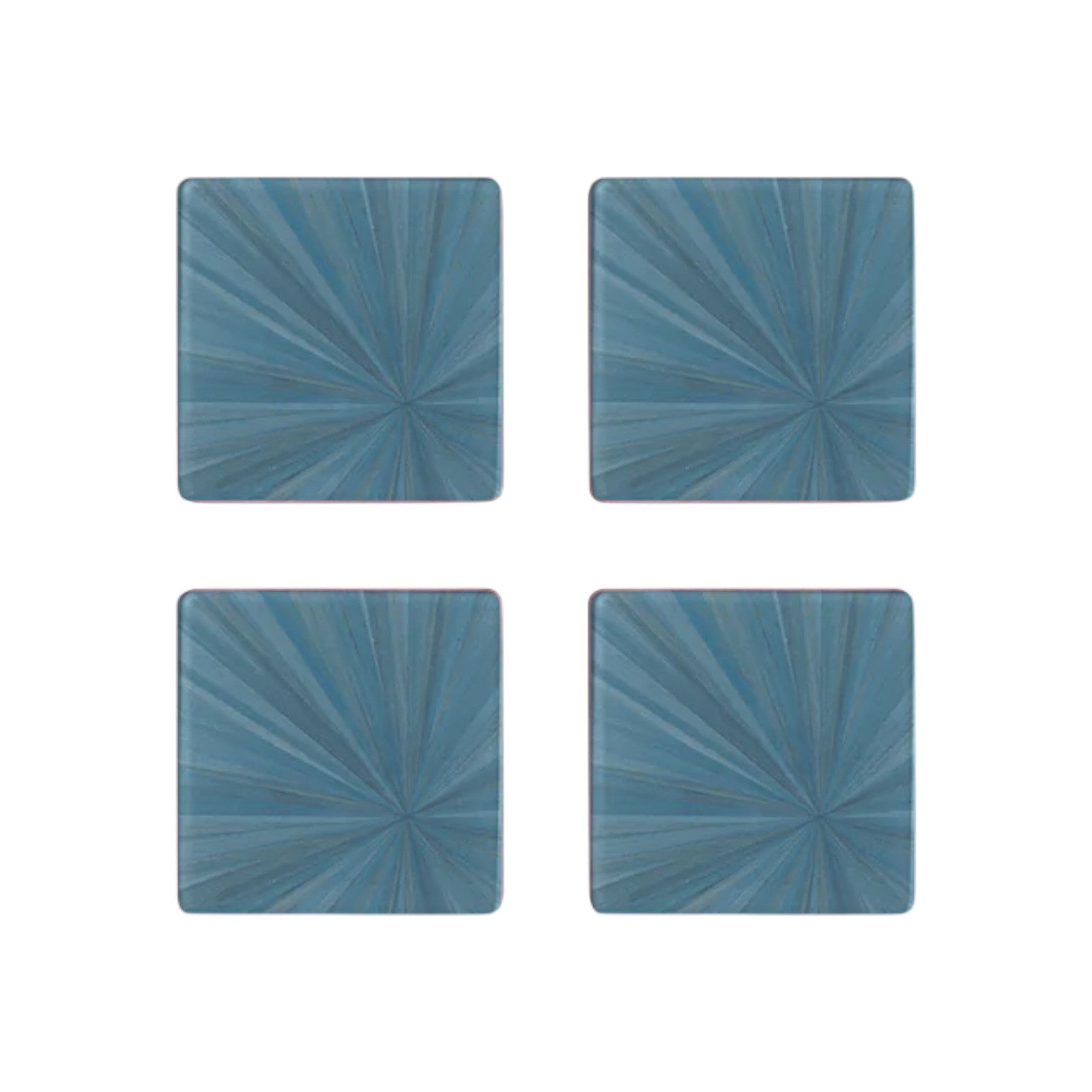 Four blue square tiles from HestiaLiving’s Soleil Tribeca Collection showcase a sunburst motif in a 2x2 grid on white, perfect for elevating any table setting.