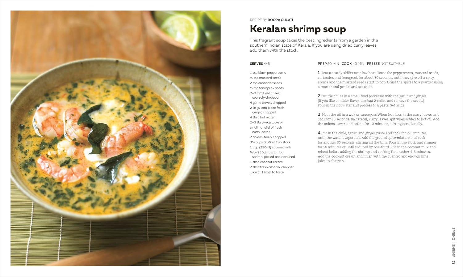 A bowl of Keralan shrimp soup, featured in The Soup Book from Penguin Random House, is garnished with shrimp and green herbs, and sits on a bamboo mat beside lime wedges and a spoon.