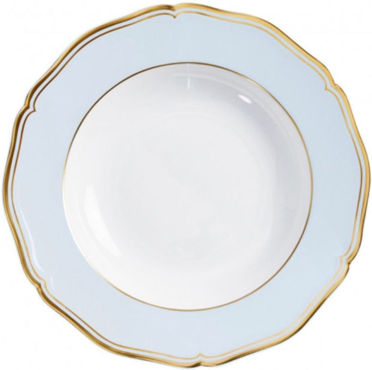 A Raynaud Mazurka Or Fond Bleu Gris dinnerware plate in white porcelain, featuring a light blue rim, gold trim, scalloped edge, and a shallow central bowl.