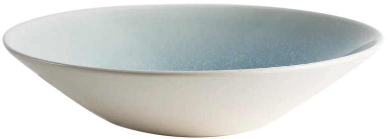 From the Vuelta Ocean Blue Collection by Jars, this shallow round ceramic bowl features a white exterior and light blue ocean glaze interior, radiating timeless elegance against a white background.
