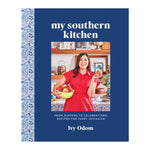 Cover of "My Southern Kitchen" by Abrams, showing the author Ivy Odom holding apples in a kitchen with decorative shelves in the background.
