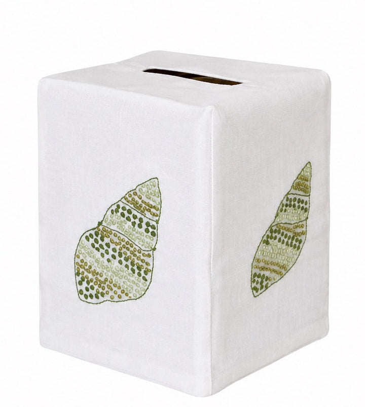 Bring a touch of elegance to your space with the Haute Home Speckled Conch Coaster & Bath Collection: this white tissue box cover features two green, embroidered leaf motifs on its visible sides and a top slot for tissue dispensing, blending classic Italian linen craftsmanship with refined linen home decor.