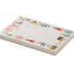 The Spring Farm Notepad by Rifle Paper Co. features rabbits, flowers, carrots, eggs, a basket, house, and hen around a white border—perfect for daily notes with easy tear-off sheets.