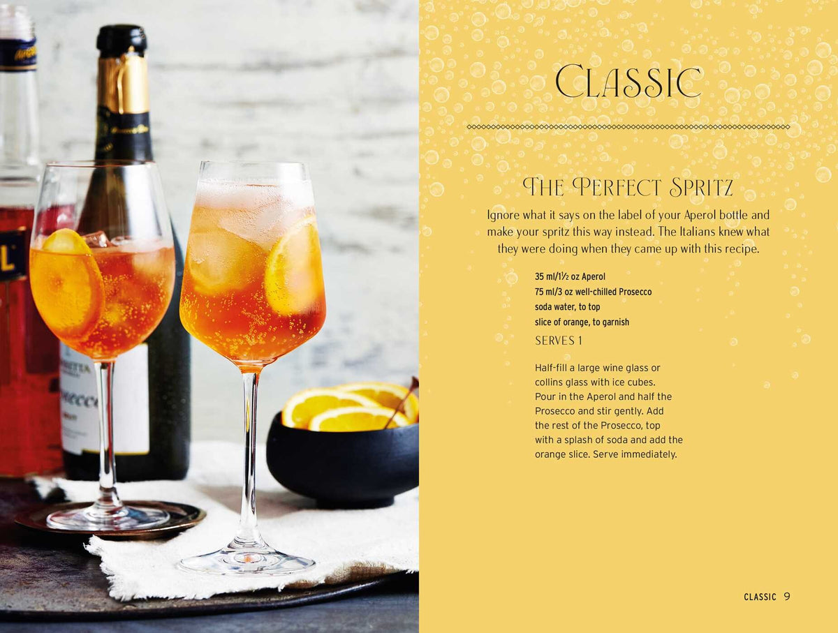 Two glasses of Spritz Cocktails by Simon & Schuster with ice and orange slices sit on a table, accompanied by Aperol, prosecco sparkling wine, and a metal jigger—the perfect ingredients for crafting classic Italian amaro spritz beverages.