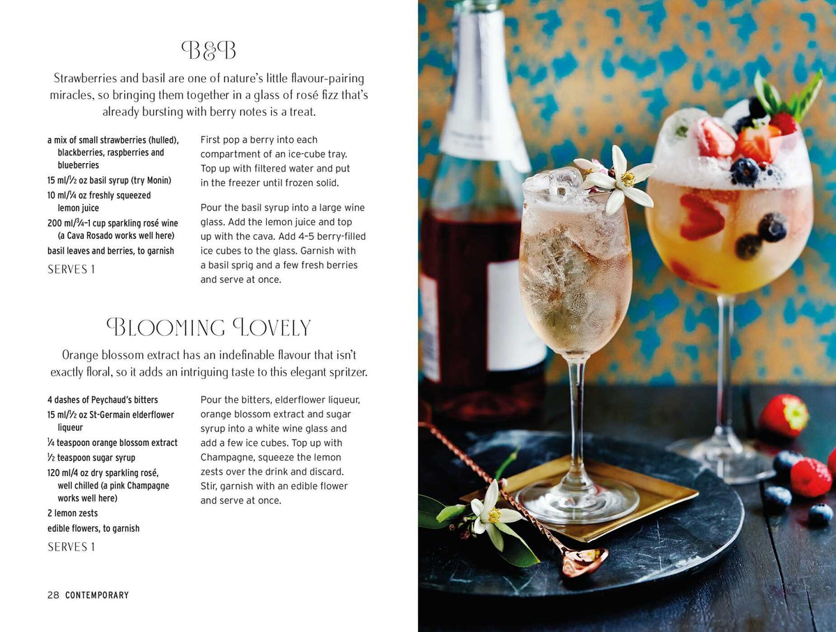 Two glasses of Spritz Cocktails garnished with fresh fruit and herbs sit on a table next to a bottle of rosé, with cocktail recipes from Simon & Schuster displayed on the left page.