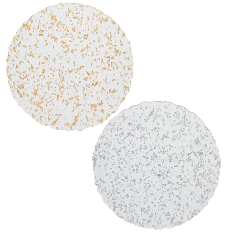 Two round plates—one with gold, one with silver specks—rest on white, evoking celestial elegance inspired by the Kim Seybert Stardust Placemat Collection.