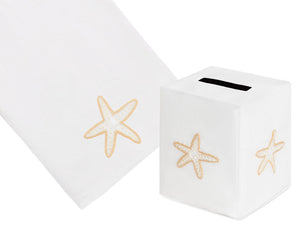 The Playful Starfish Bath Collection in Cream by Haute Home features a linen tissue box cover and towel, both hand embroidered with elegant beige starfish motifs.