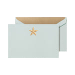 The Crane Gold Starfish Beach Glass Flat Card Set features a pale blue card with a gold embroidered starfish, paired with a matching envelope and gold interior—a beach stationery collection perfect for any occasion.