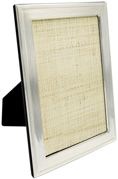 The Tizo Design Sterling Frame with Border Collection features a textured mat and mesh border, an empty photo space, and stands upright on a flat surface with its support leg extended.